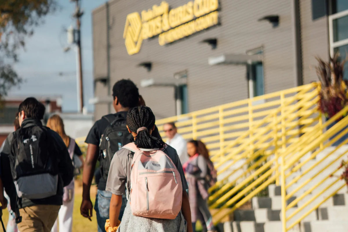 Person walking up stairs with backpack