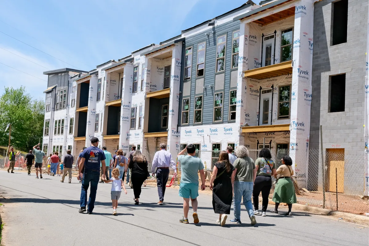 People walking past modern apartments