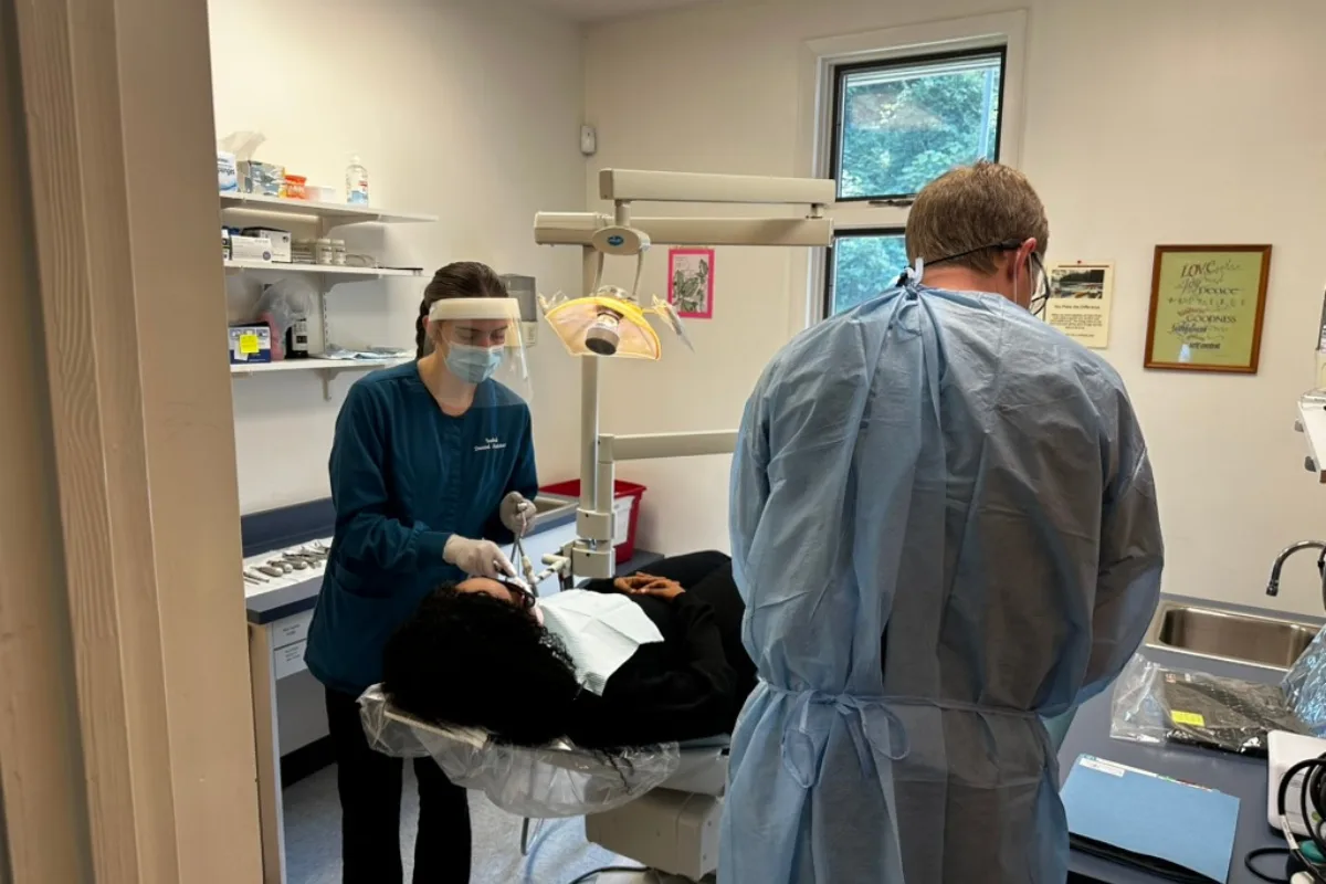 Healthcare workers assisting patient