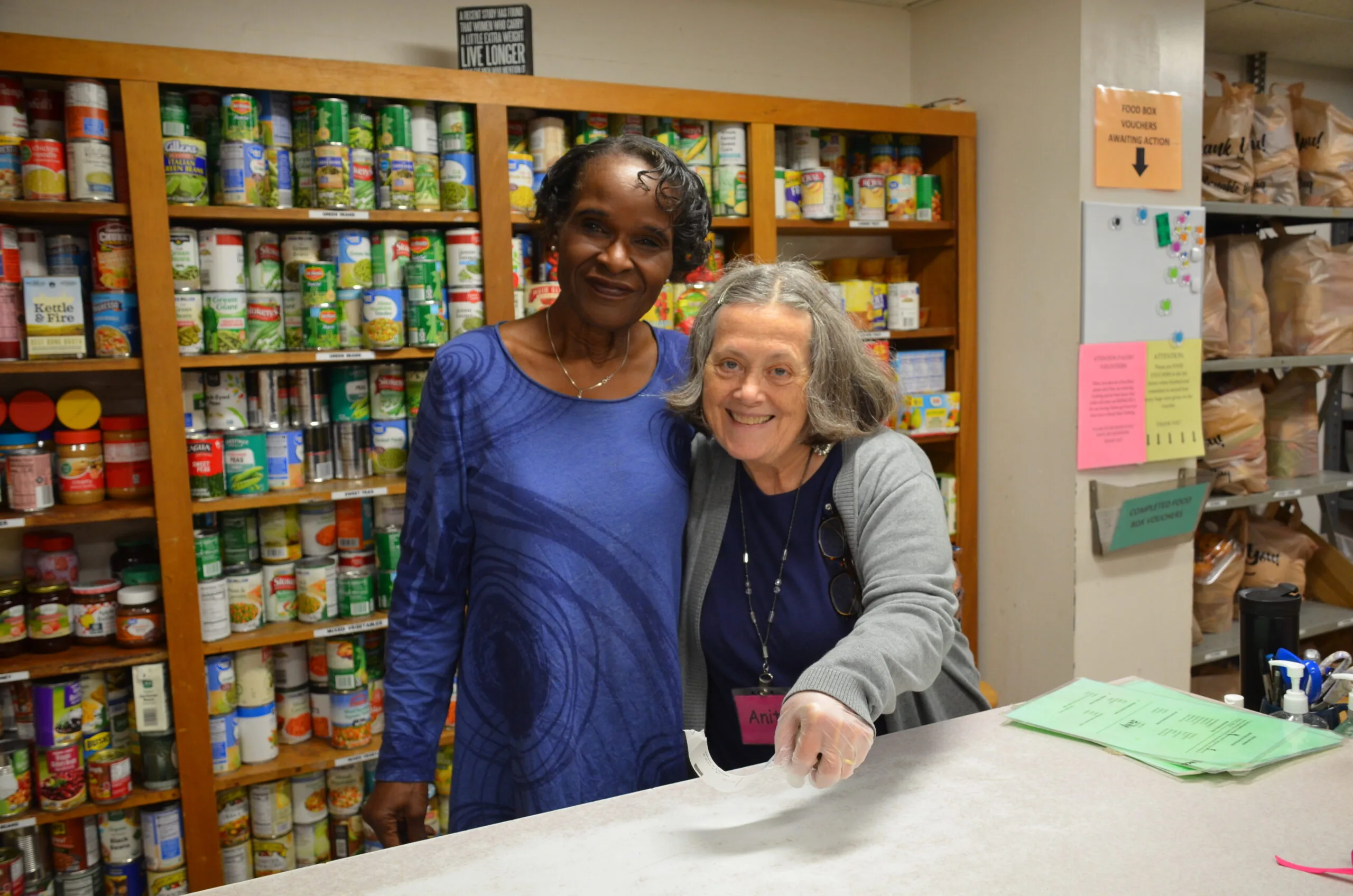 Two women smiling in indoor setting