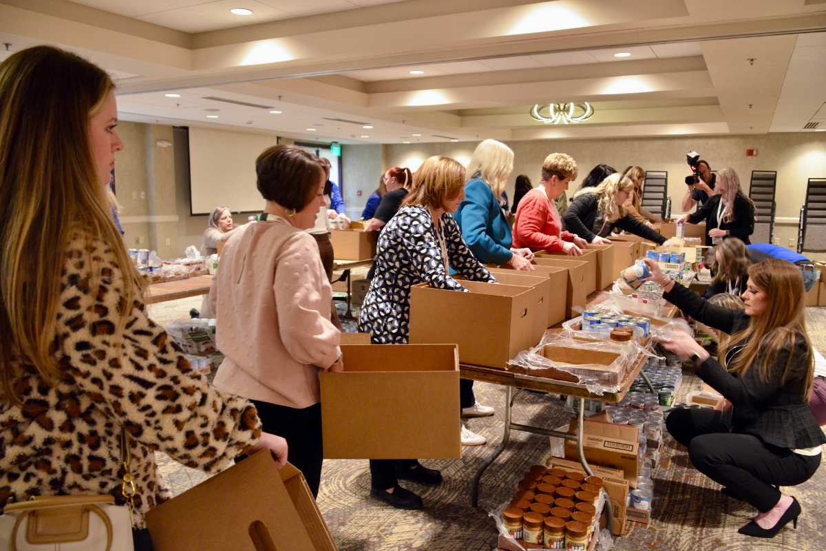 Volunteers packing boxes in warehouse