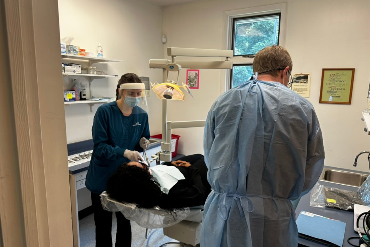 Medical staff assisting patient in clinical setting