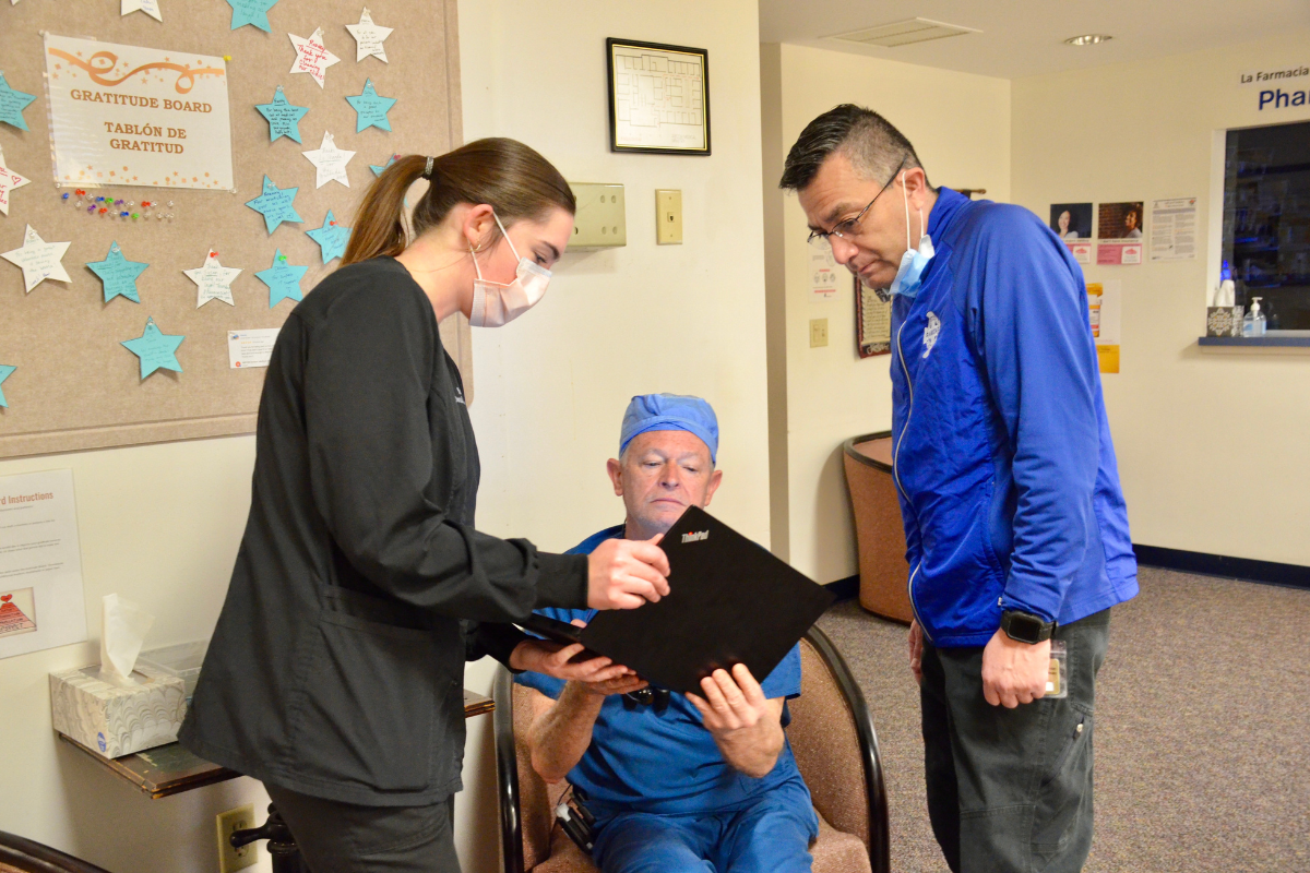 Healthcare worker assisting seated patient