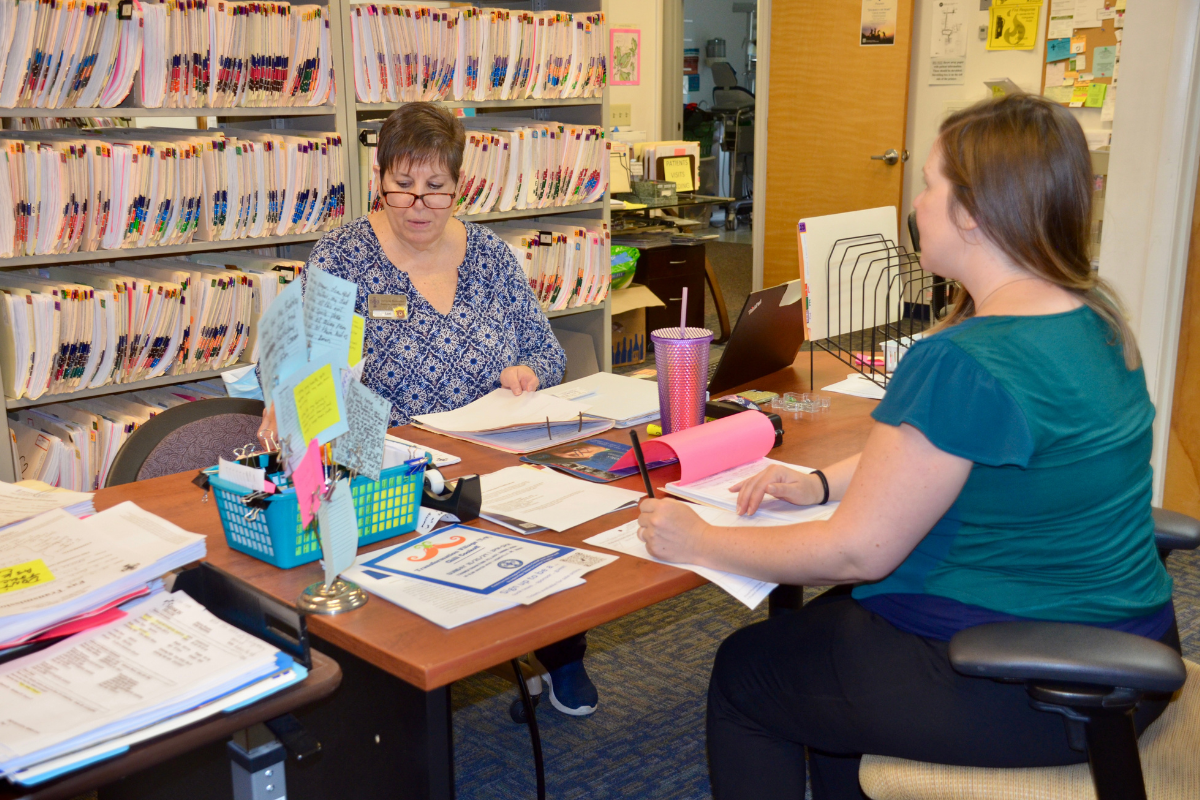 People working on crafts or activities at table