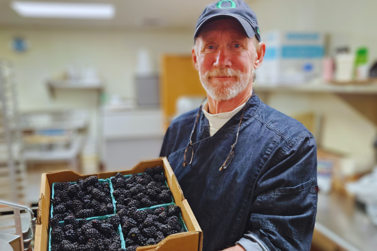 Man holding crate of produce