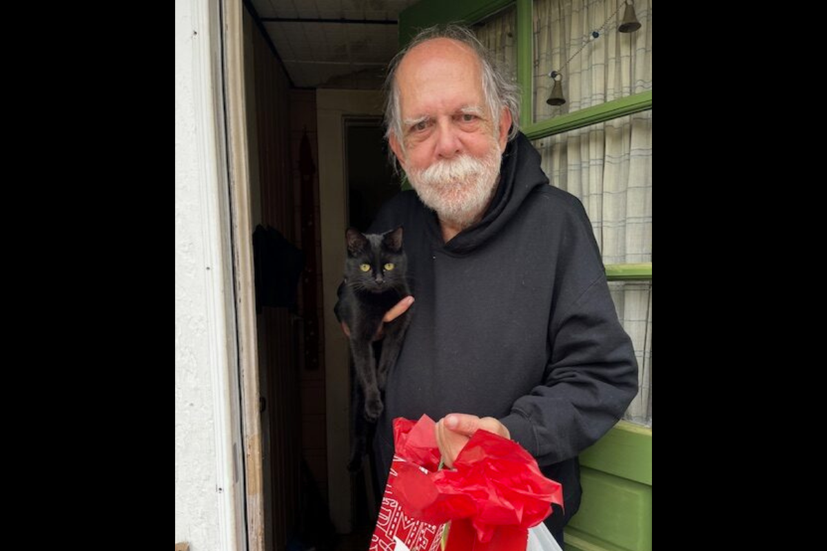 Man standing in doorway smiling