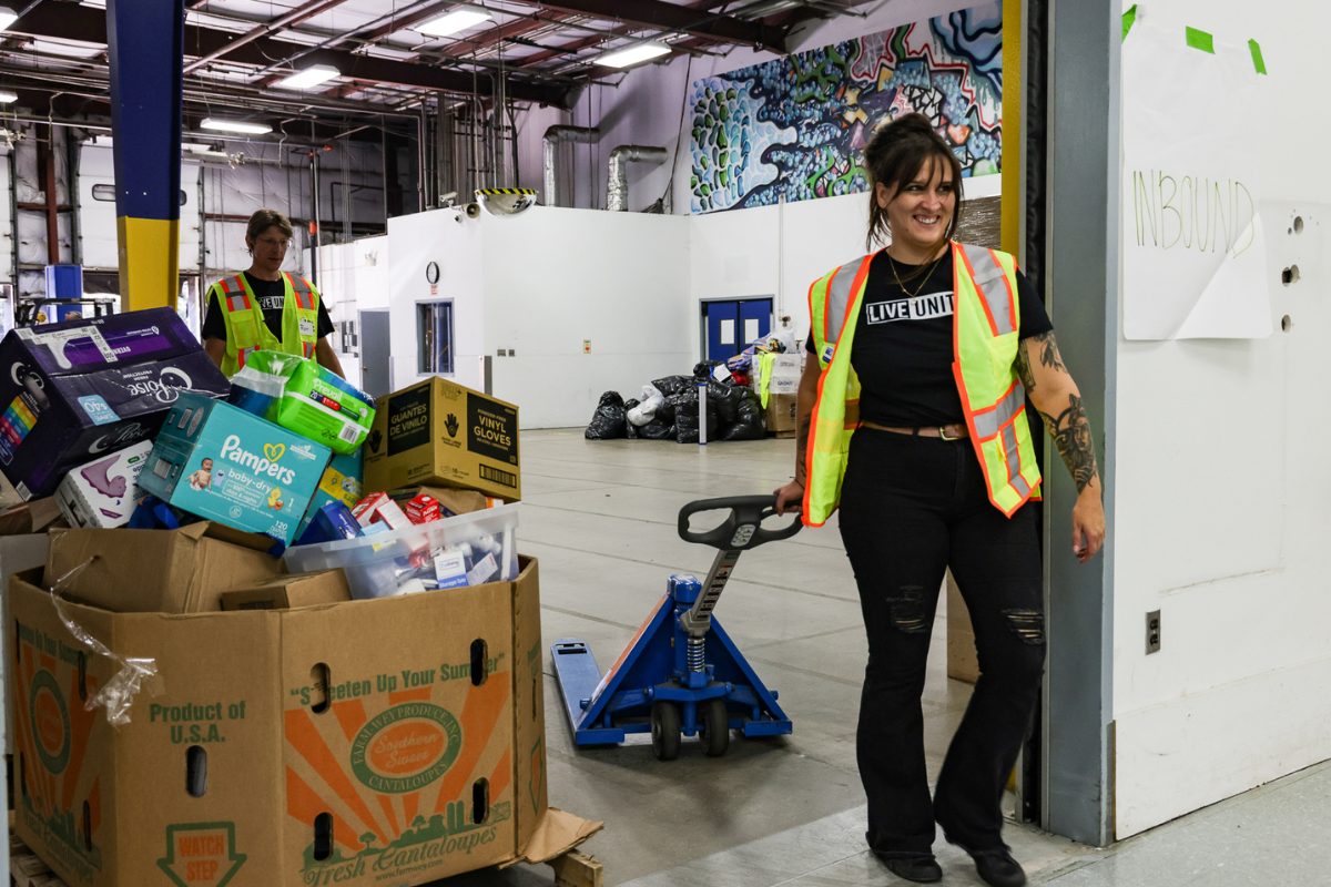 Volunteer moving donation boxes with pallet jack