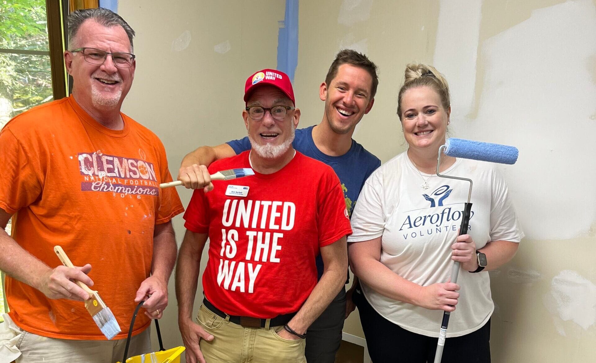 Volunteers posing in branded shirts