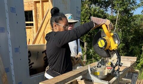 Person using power tool on construction site