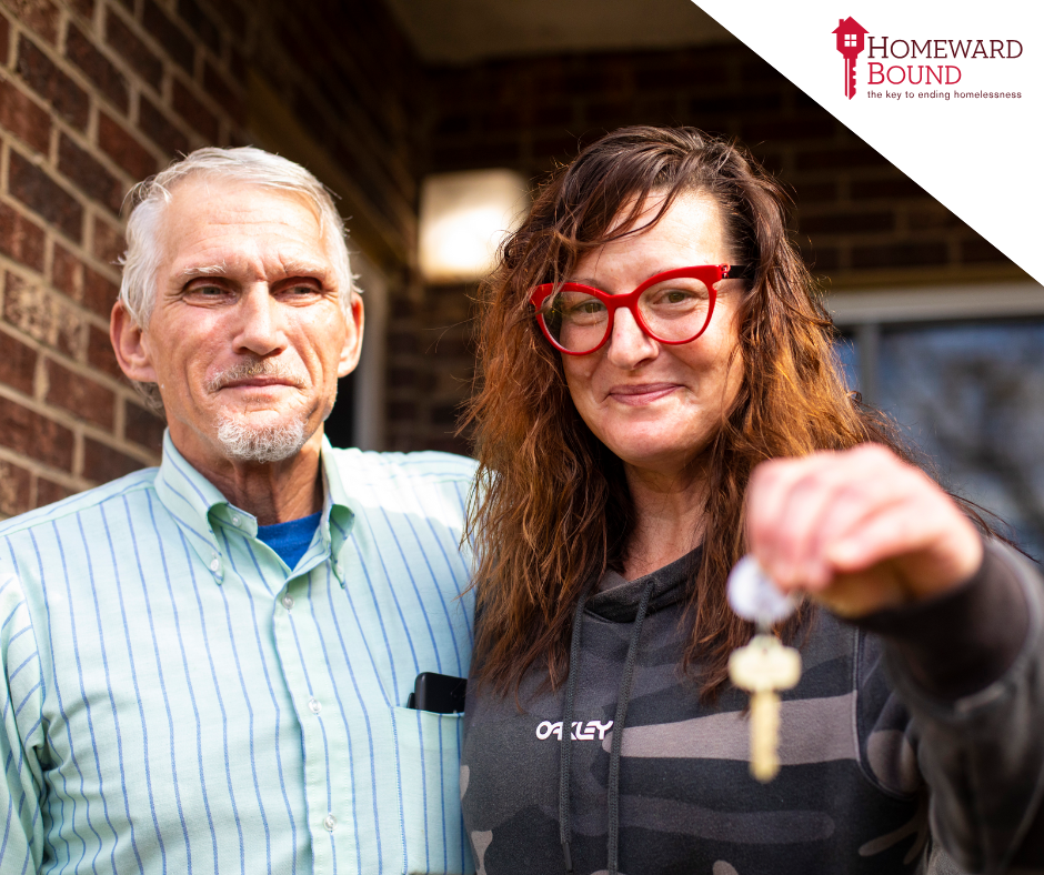Two people posing together at event