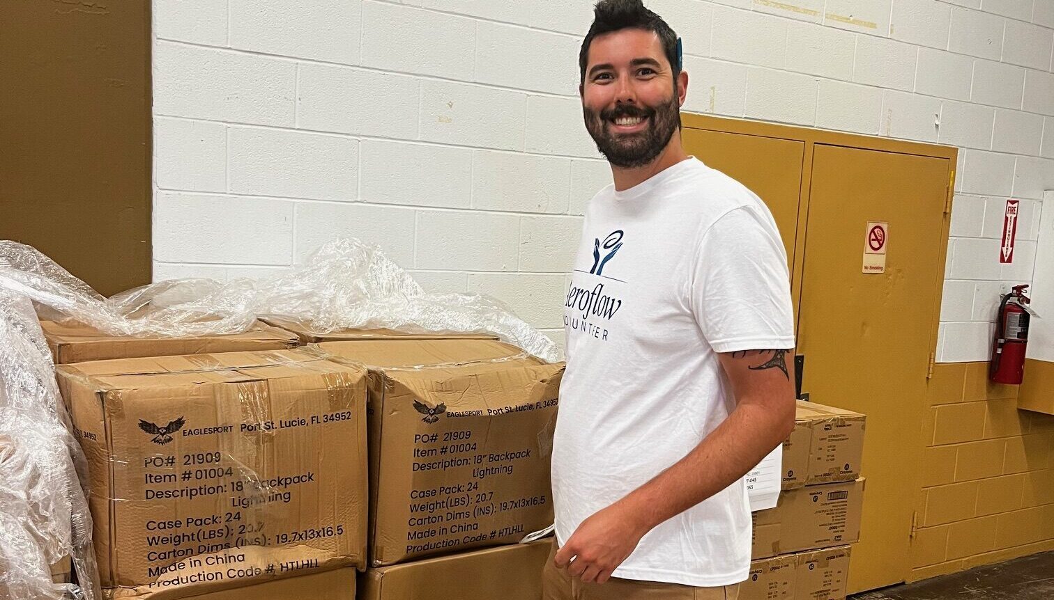 Man standing with boxes in warehouse